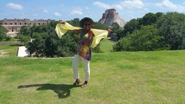 Freddie with a flowing yellow scarf at the Uxmal Mayan ruins